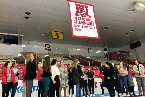 Past and current members of the BU Figure Skating Club gathered at Walter Brown Arena today to witness the unveiling and raising of their new championship banner.