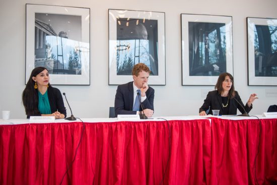 Nicole Ramos, Joe Kennedy III, and Sarah Sherman Stokes sit behind a table with a red wavy tablecloth as panel members
