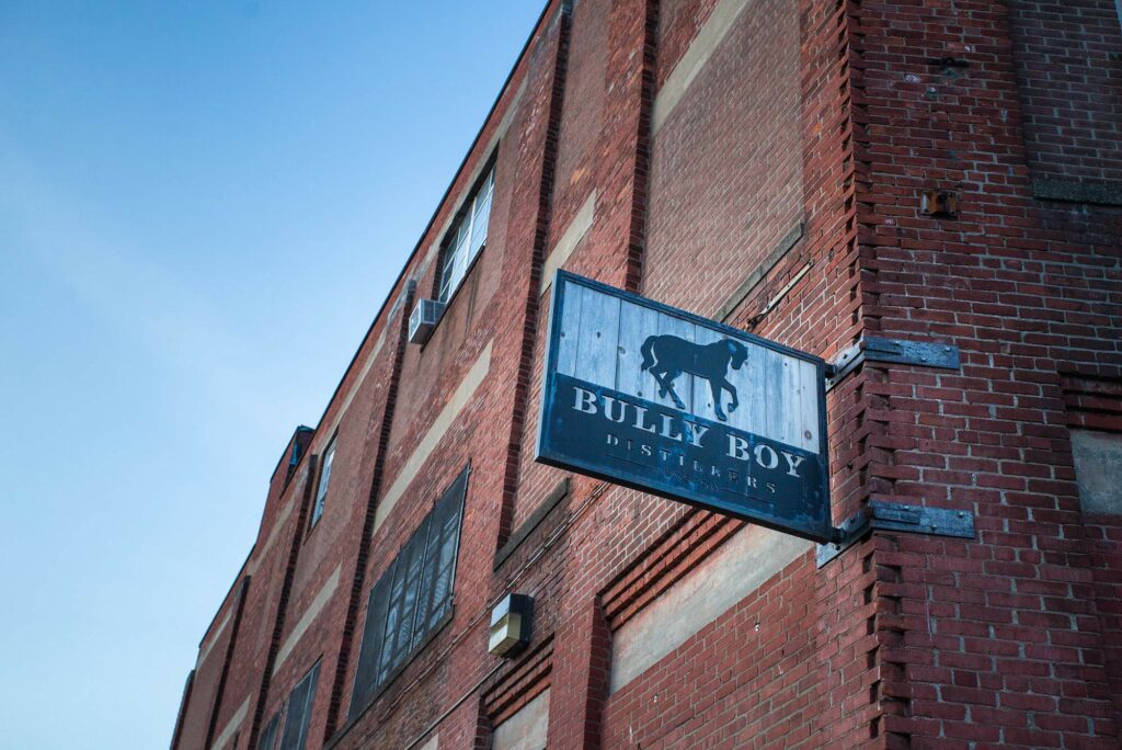 Photo of a sign on a brick building that says "Bully Boy Distillery"