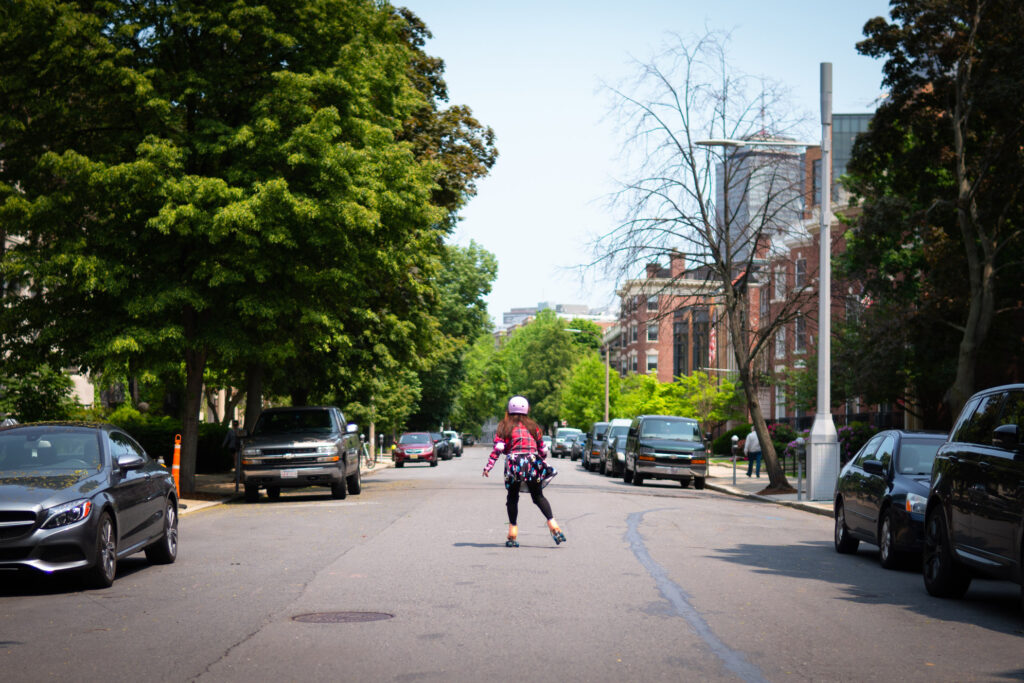 A Boston University student roller-skates down Bay State Road.