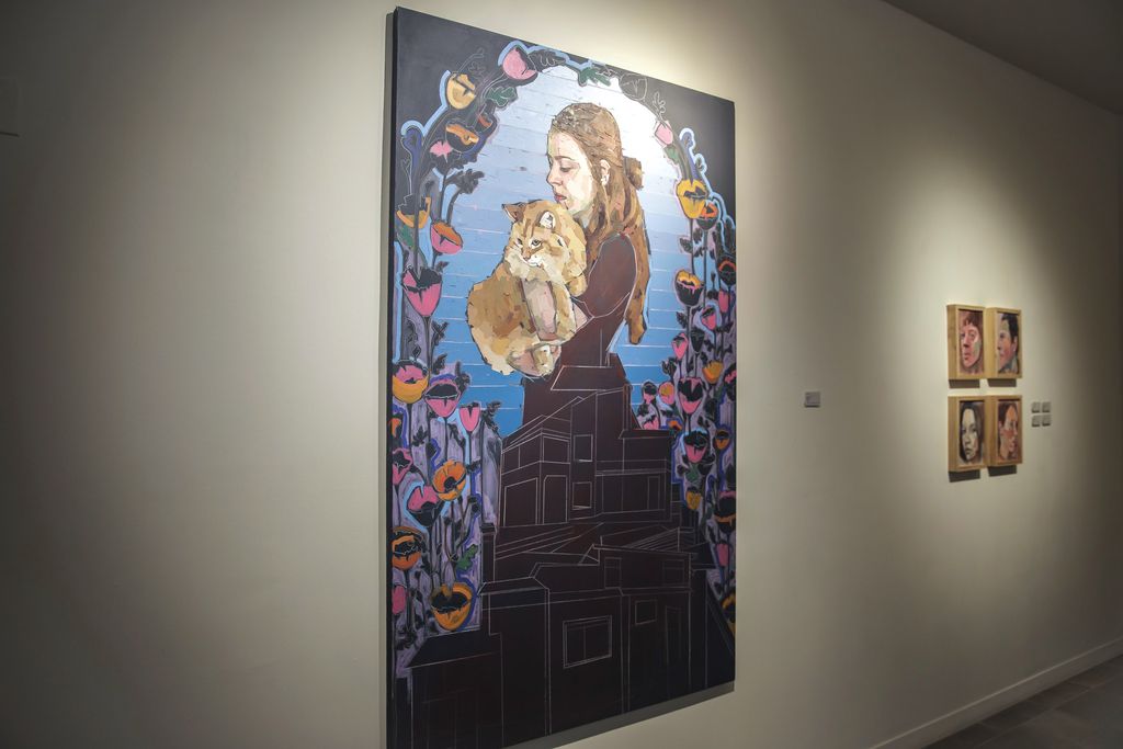 A painting depicting a woman holding a cat by Mia Cross
