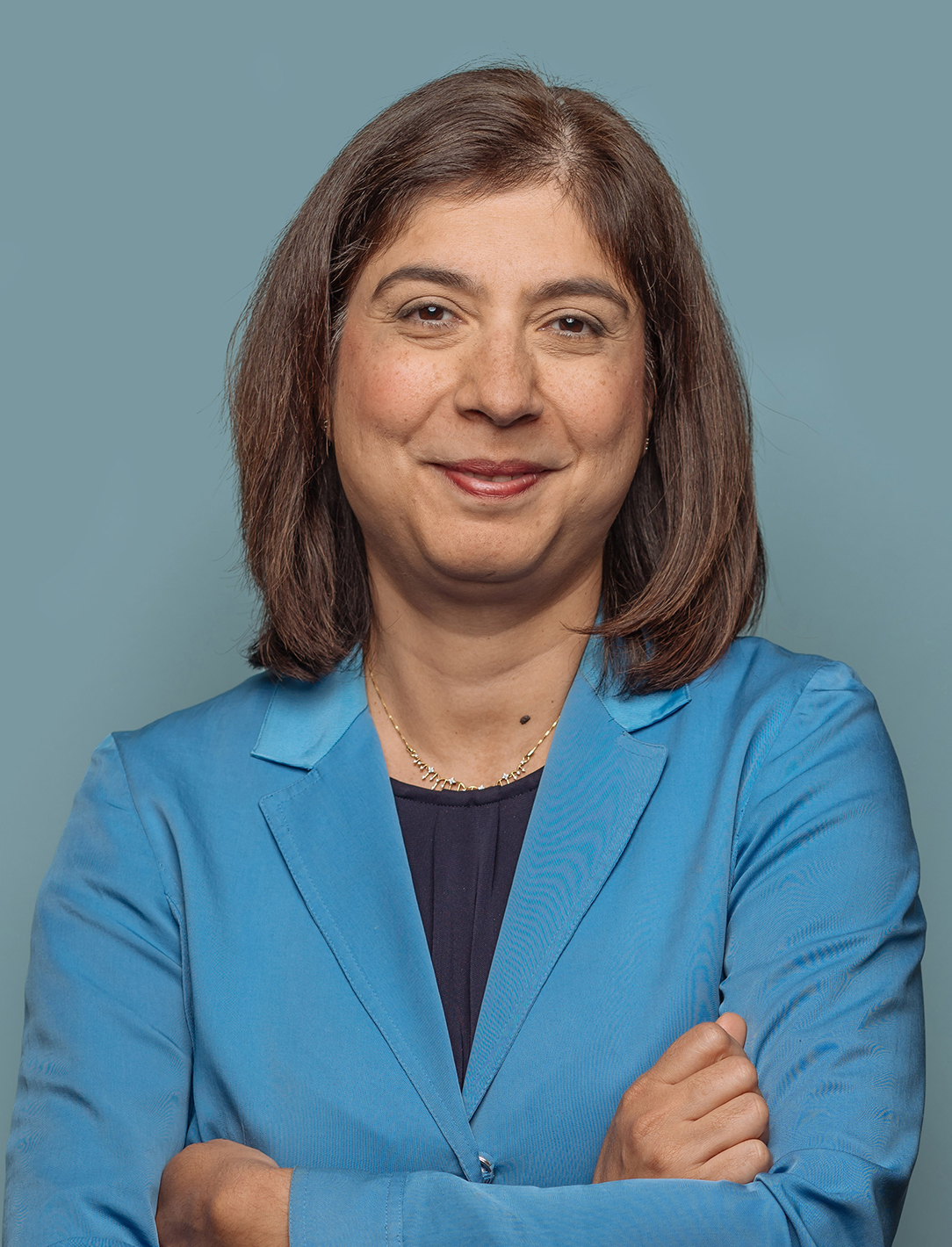 a portrait of Reshma Kewalramani, the first female CEO of Vertex, a large biotech firm
