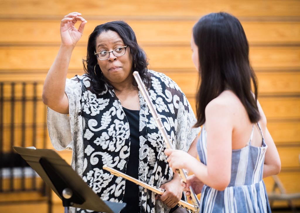 Coleman instructs a student playing the flute