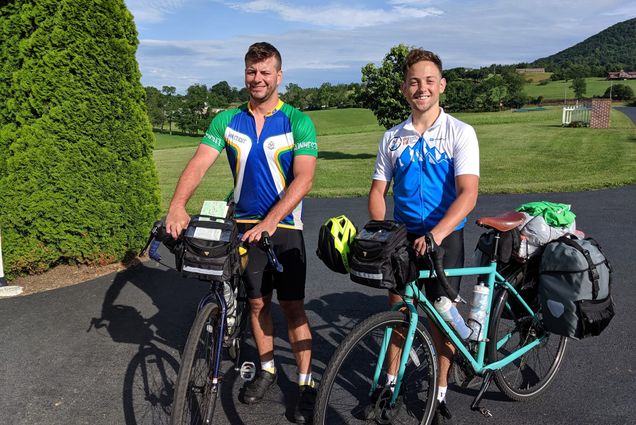 Albert Blake (left) and Conrad Baer (Wheelock’19) stand with their bikes