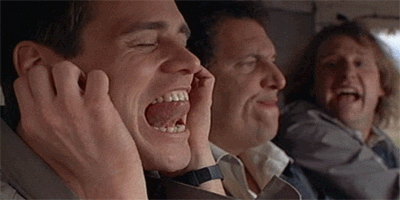 GIF of Jim Carrey with his fingers in his ear as earplugs