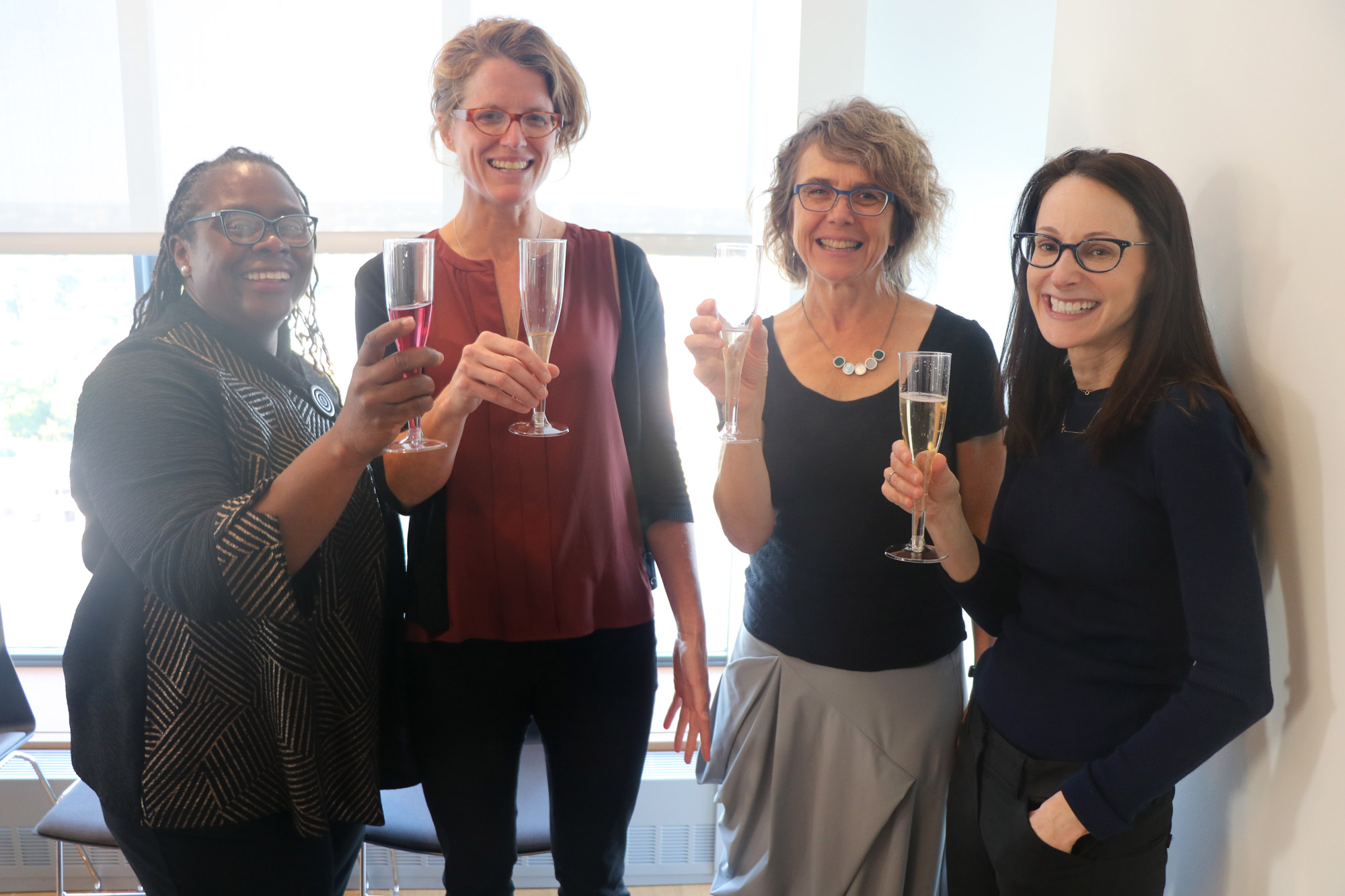 Angela Onwauchi-Willig (from left), Kristin Collins, Stacey Dogan, and 2019 MacArthur Fellowship winner Danielle Citron celebrate Citron's MacArthur Fellowship.