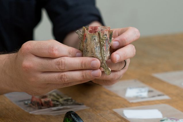 Joe bagley holding a Chinese lantern artifact found in an archaeological dig of Boston's Chinatown neighborhood.