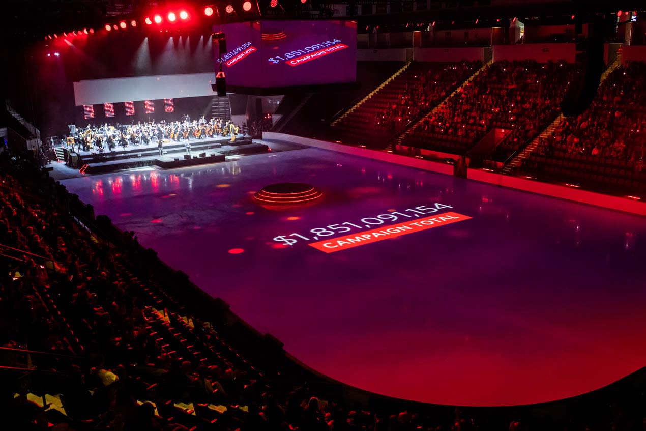 The total amount of money raised during the Campaign for Boston University--$1,851,091,154--is projected on the ice at Agganis Arena during the Celebrate BU campaign finale.