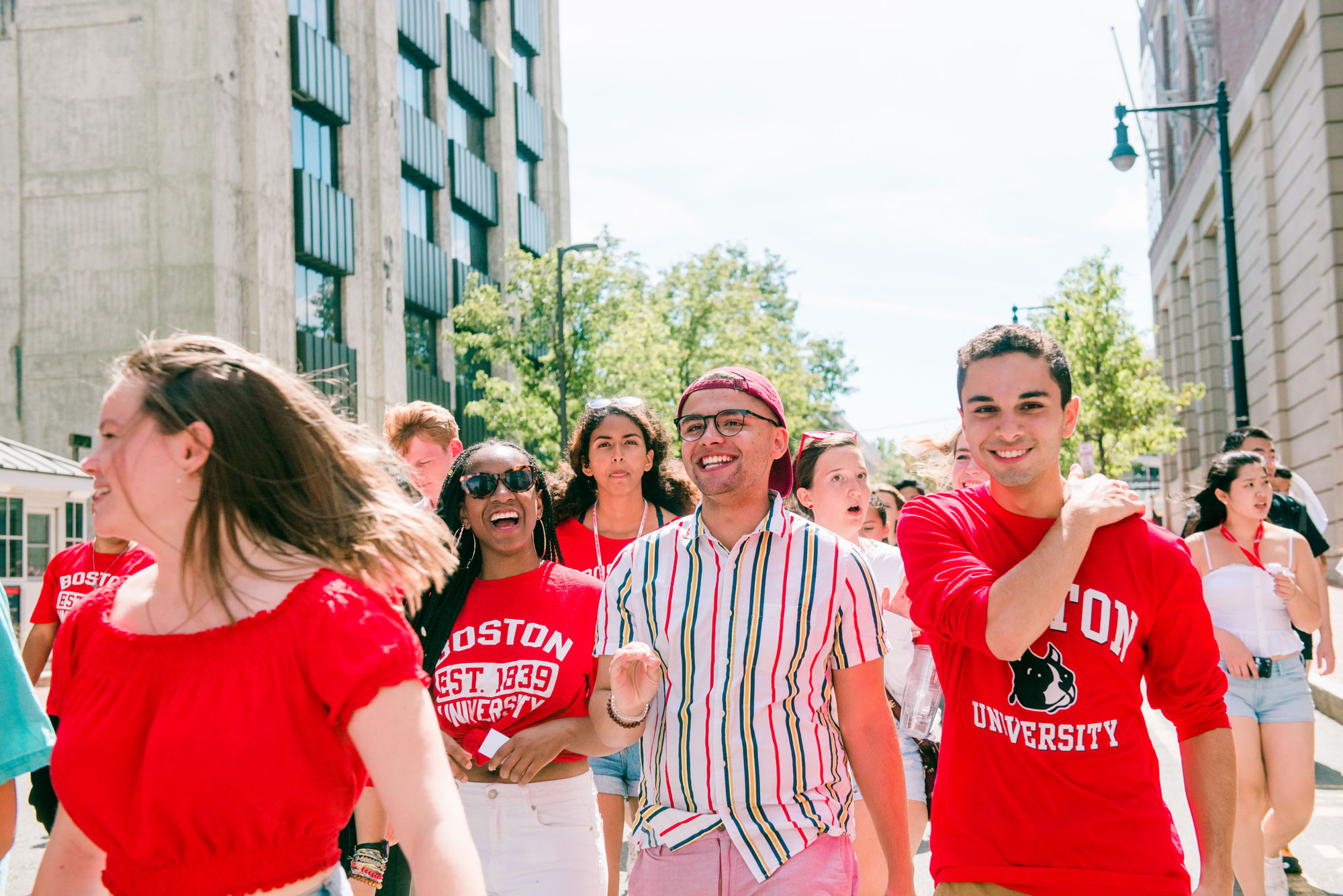 Students sporting Boston University apparel walk down comm ave, during the matriculation parade