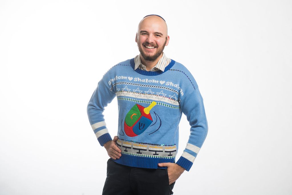 Connor Dedrick (Questrom ’21) wearing a blue sweater with a dreidel on it