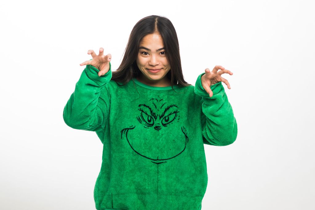 Bailey Katsumata-Smith (CAS’20) wearing a bright green sweater with the grinches' face on it