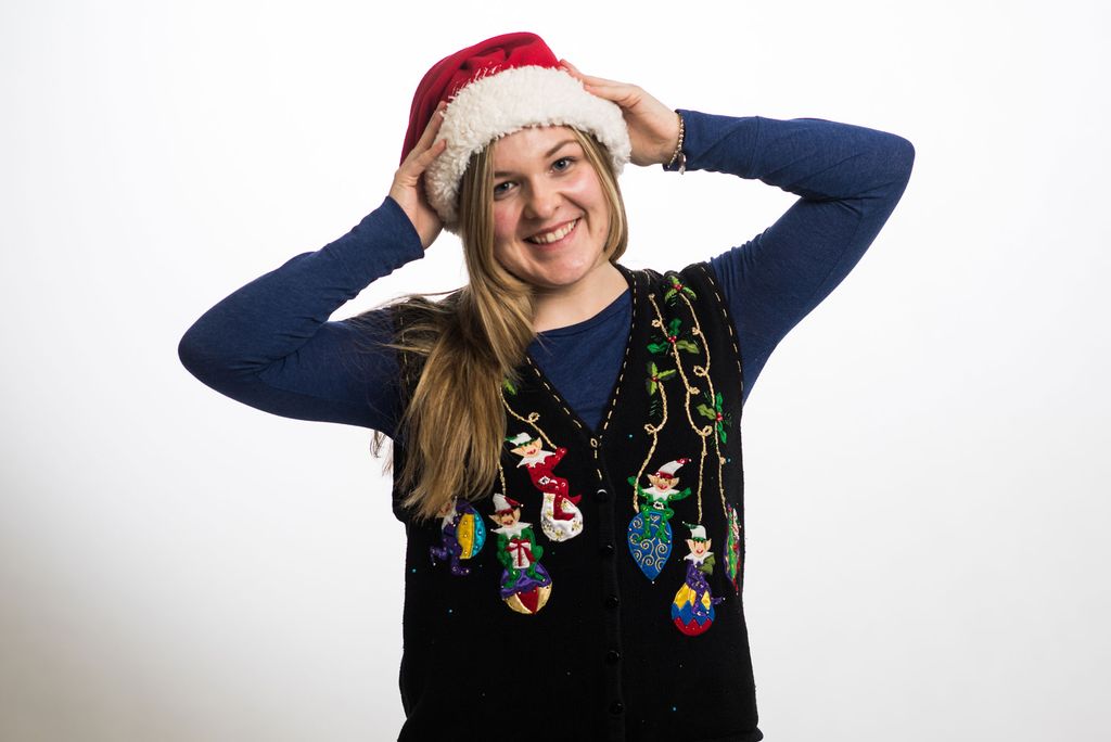 Kathryn (Katie) Hansen wearing a santa hat and sweater vest decorated with elves