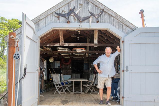 Jay M. Cashman poses for a photo on his island off Chatham, Mass.