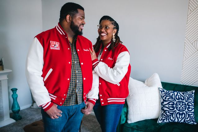 A photo of Joshua Reynolds (CFA’11, MET’13) and Danielle Galloway (CAS’15) wearing Boston University letterman's jackets