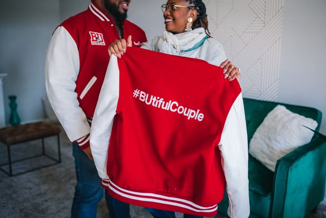 A photo of Joshua Reynolds (CFA’11, MET’13) and Danielle Galloway (CAS’15) with their Boston University letterman's jackets