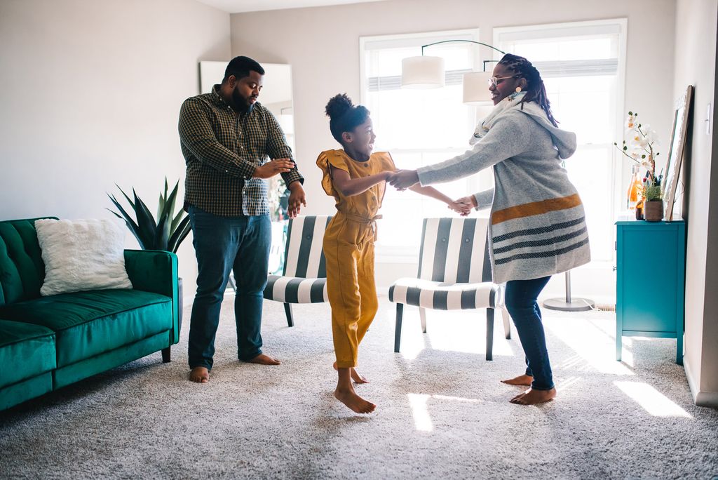 A photo of Joshua Reynolds (CFA’11, MET’13) and Danielle Galloway (CAS’15) dancing with Danielle's daughter Melody, age 7.