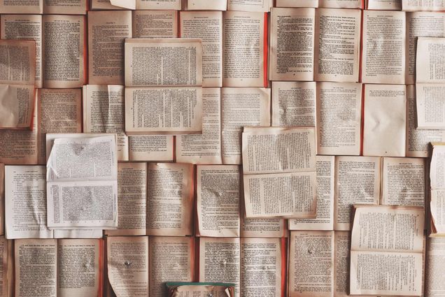 Paperback books stacked on top of each other..