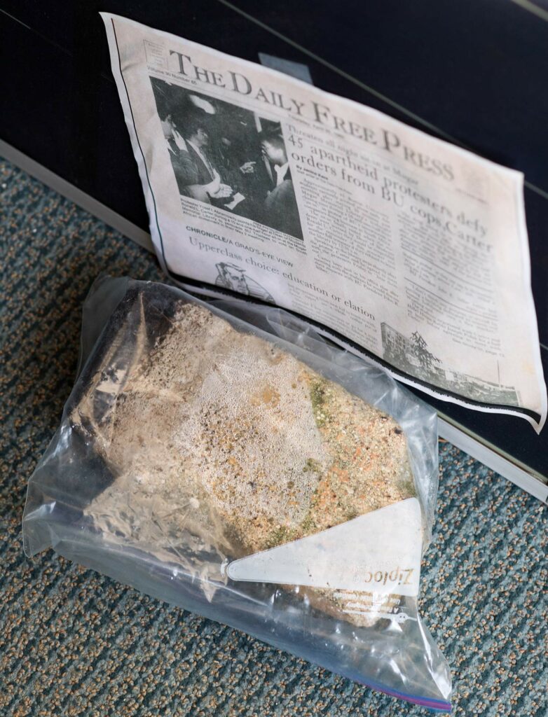A brick sealed in a plastic freezer bag on the floor of Nathan Phillips’ office. He took it from the ground where the natural gas compressor is being built; it very likely contains asbestos.