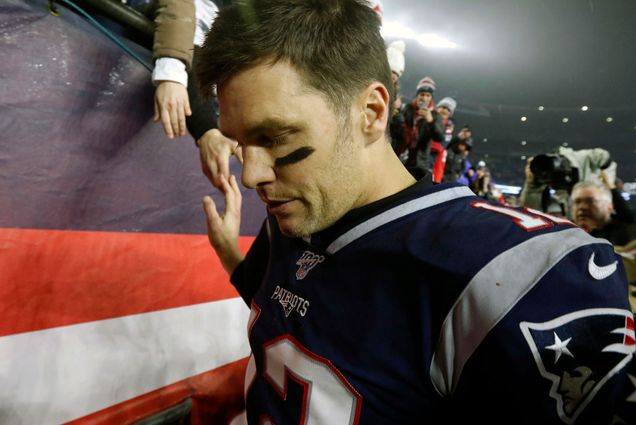 A photo of Tom Brady leaving the field after his last game in a Patriots uniform