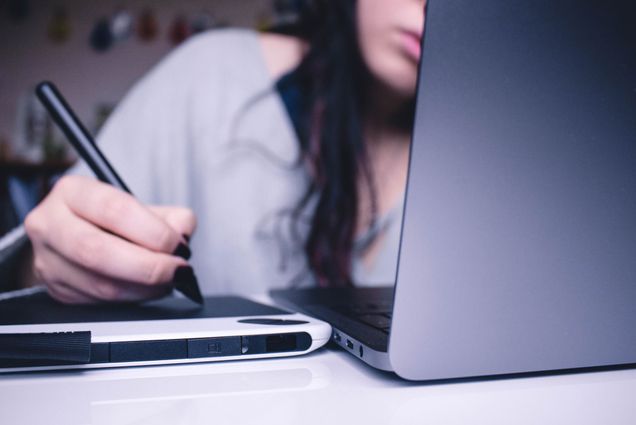 A photo of a woman at a computer