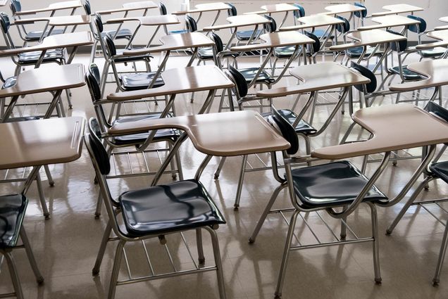 Photo of empty desks in a classroom.