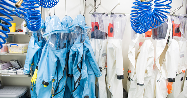 Photo of blue suits hanging up in a lab at BU's NEIDL.