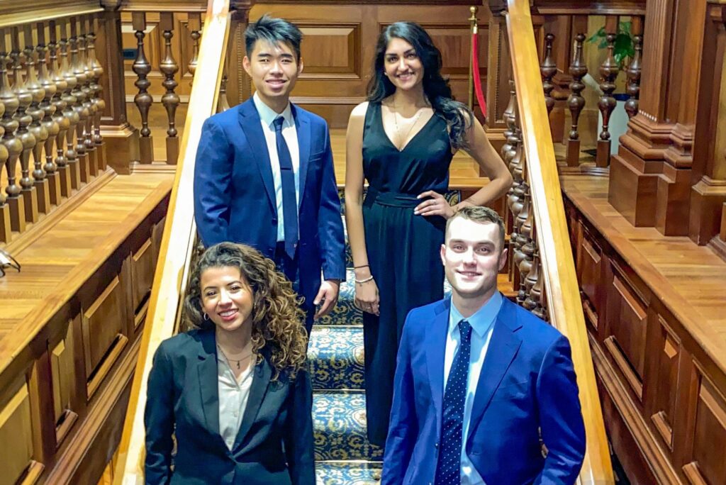 Photo of the students of igniteBU standing on a fancy staircase; the group includes: President: Collin McCormick (CAS’21, Pardee’21), Executive VP: Juliana Torrez-Ortiz (CAS’21), VP Finance: Kevin Yu Shi (Questrom’22), VP Internal Affairs: Noor Siddiqui (Sargent’21).