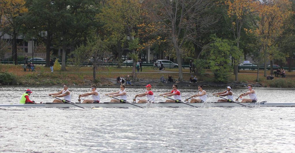 Photo of Hayden Folgert (Questrom’20) and fellow seniors rowing on the Charles River as people on the esplanade watch.