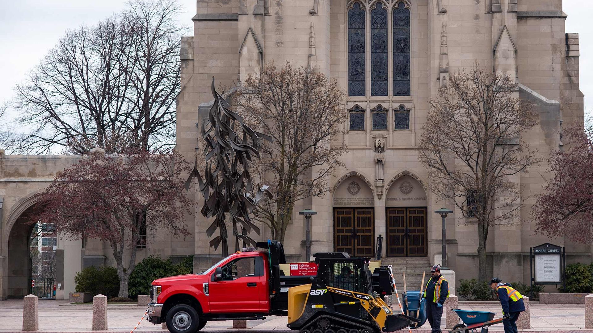 Image of facilities grounds crews moving forward with Spring campus cleanup and planting despite the lack of people due to COVID-19. Marsh Chapel is seen in the background.