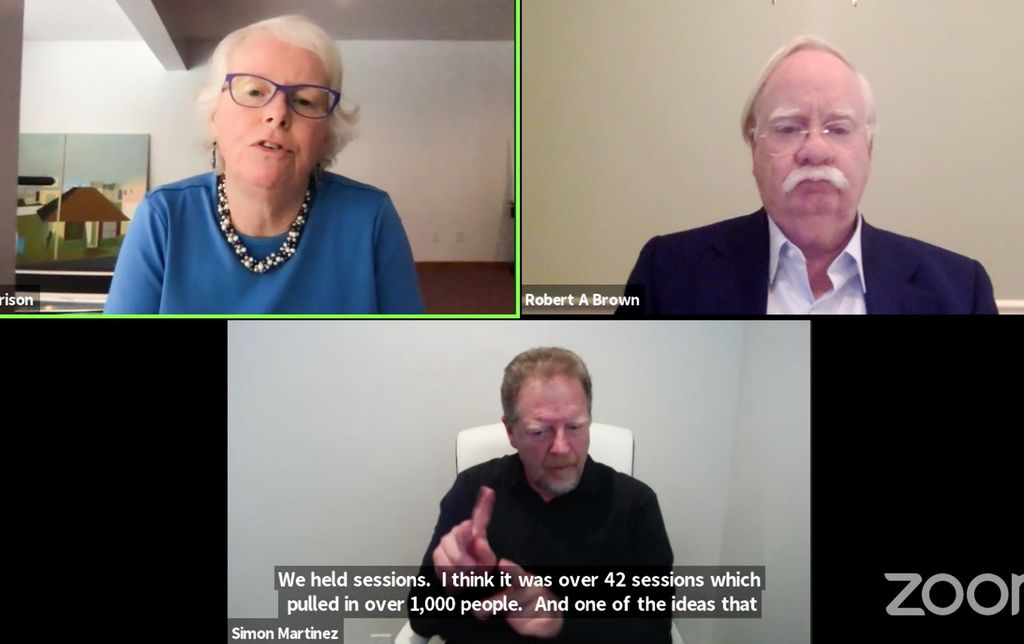Screenshot of zoom discussion between Jean Morrison, top left, Robert A. Brown, right, and ASL Interpreter Simon Martinez. Closed captioning reads "We held sessions, I think it was over 42 sessions which pulled in over 1,000 people. And one of the ideas that..."