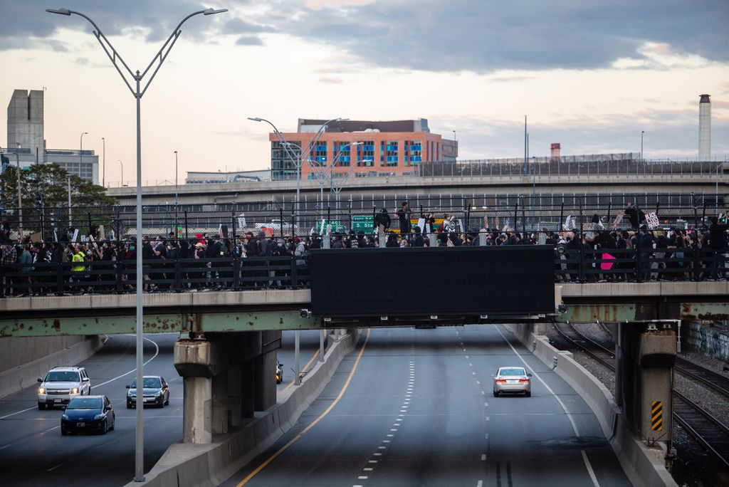 Protestors march over the Mass Pike in Boston