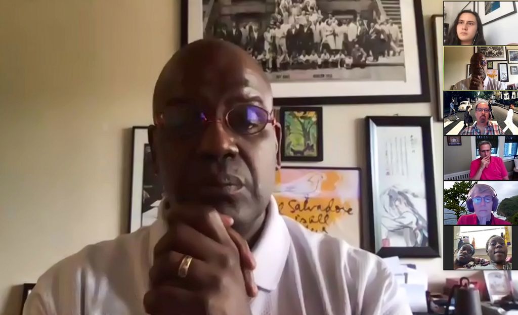 Screenshot of Dean Kenn Elmore during a Moderated Debrief Sessions at the conclusion of the Collective Day of Engagement. On the right of the screen, the faces of unnamed participants are seen.
