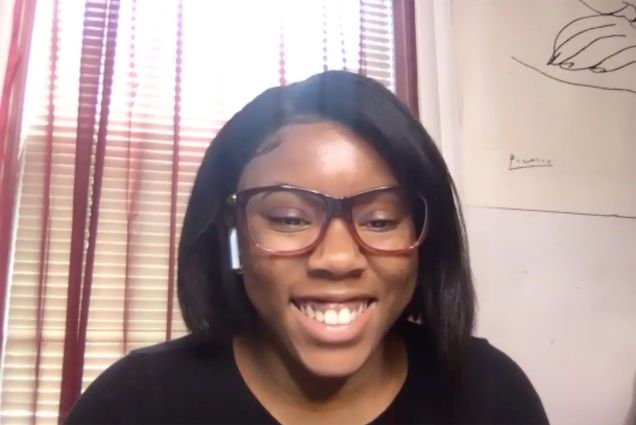 Screenshot of former Upward Bound Student Victoria Omoregie (CFA’21) on a Zoom call. Victoria wears airpods and glasses and smiles.