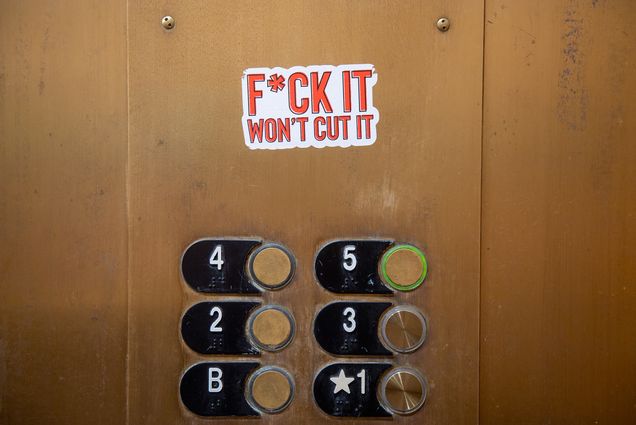 Photo of a f*ck it won't cut it sticker inside a CAS elevator on September 13. The buttons of elevator are seen below.