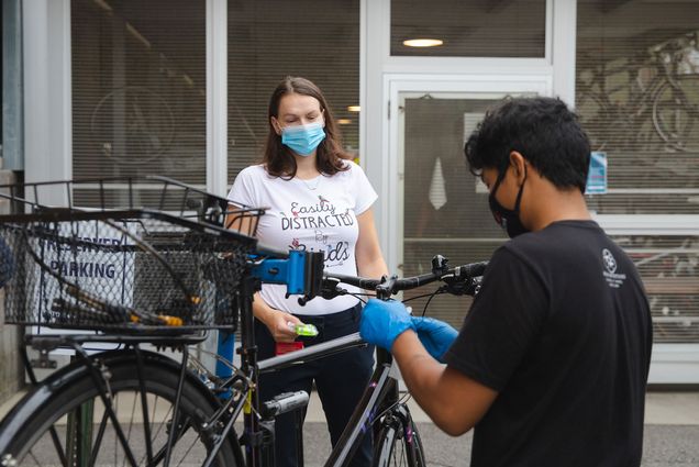 Urban Cycle's Rodell Pascua (right) inspects Kristyna Kotynkova's (post-doc) bike at the Bike tune-up event at the Boston University Medical Campus on the morning of Thursday Sept 10th.