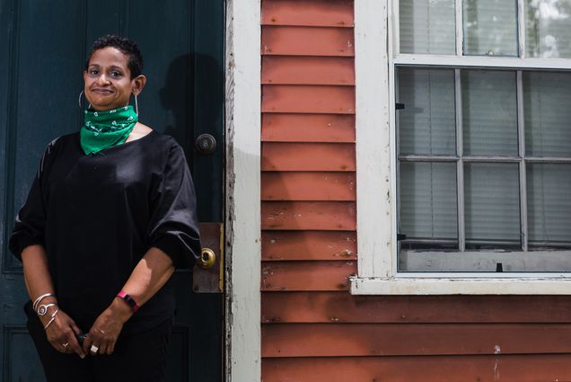 A photo of Paula Austin standing outside a house