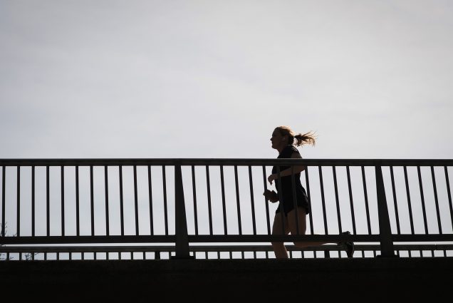 Photo of a runner in silhouette as they run across the bridge over Storrow drive near the Charles River on Tuesday, April 10, 2017.