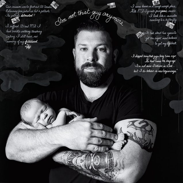 Black and white photo “Josh & Emma,” mixed media on canvas. A bearded man in a tight black shirt holds an infant in his arms. Cursive text above his head reads "I'm not that guy anymore."