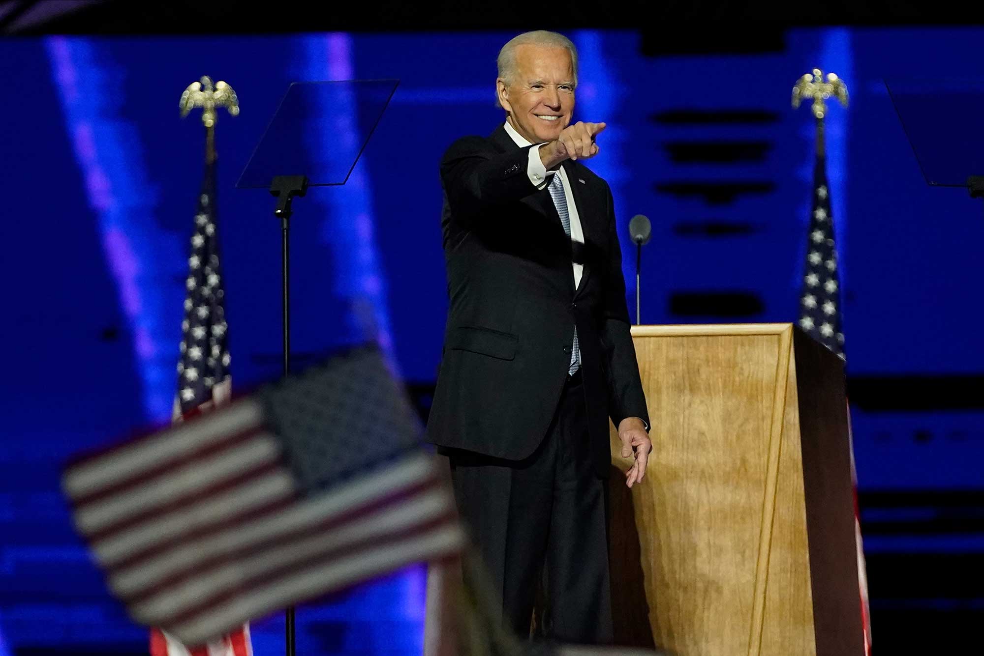 President-elect Joe Biden points at the crowd on stage after making his presidential election victory speech, Saturday, Nov. 7, 2020, in Wilmington, Del.