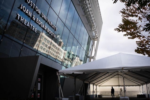 Photo of a large tent set up outside of Booth Theater the day before the election on November 2, 2020. The space is provided for political expression. The sky is gray and cloudy; one person is seen in silhouette underneath the large white tent.