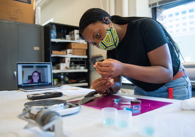 Stephanie Joseph measures the elastic properties of Jello while her lab mate watches virtually during their Physics of Food lab at Boston University.