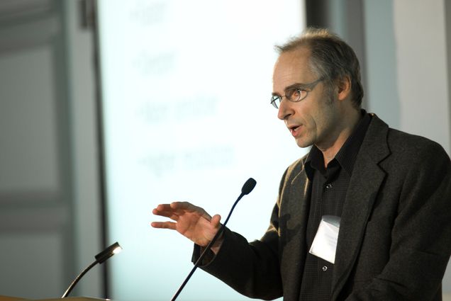 A photo of Jerome Mertz speaking at a podium