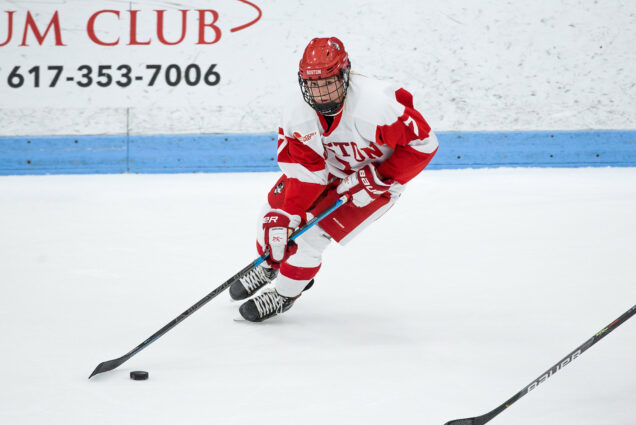 Photo of women’s ice hockey player Jesse Compher skating on the ice while possessing the puck during the 2020 Beanpot.
