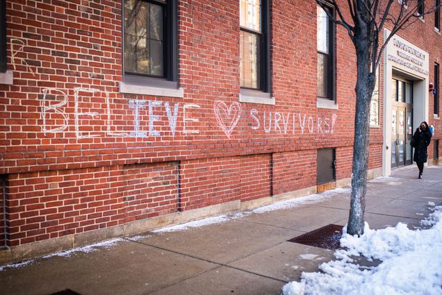 A photo of chalk graffiti on the side of a brick building that reads "Believe Survivors"