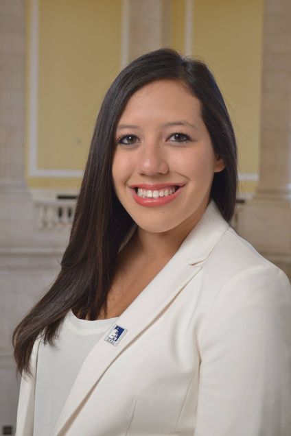 Photo Sara Garcia in a white blazer smiling.