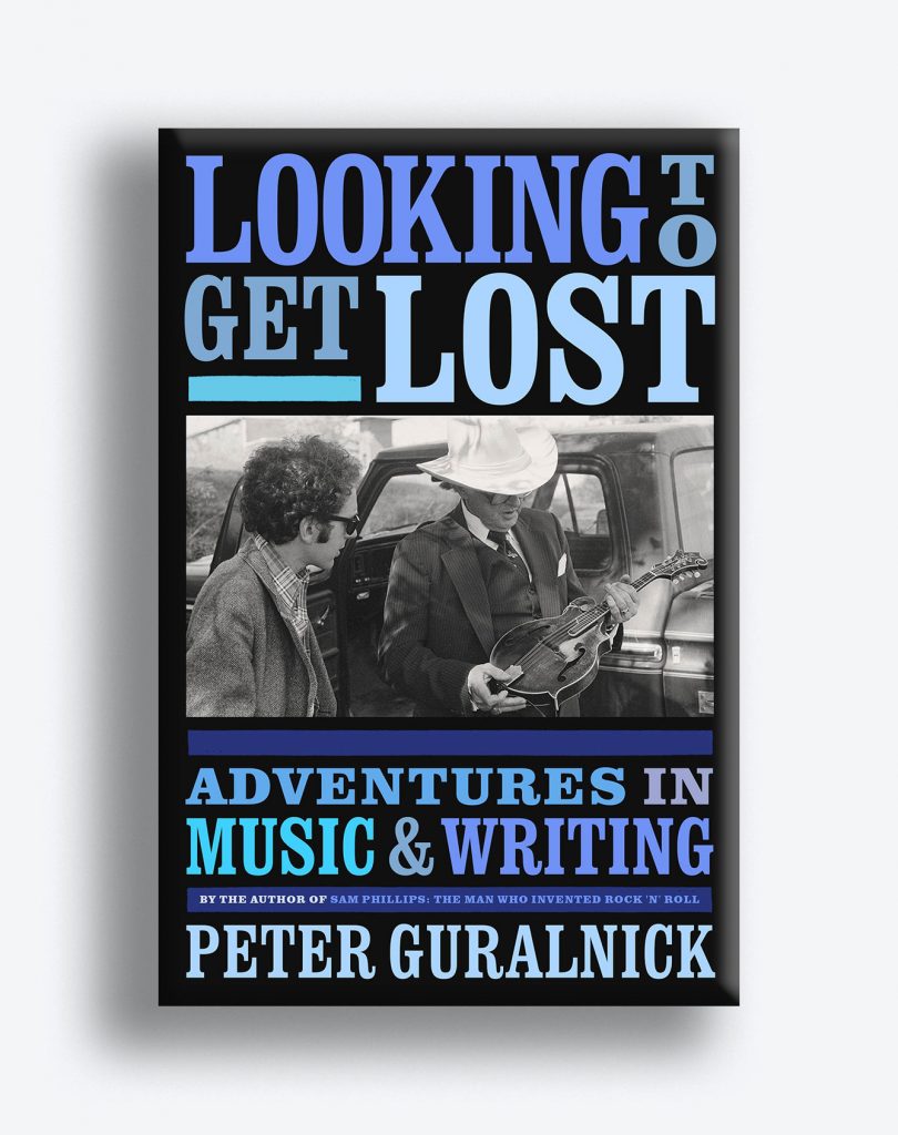 Book cover for “Looking to Get Lost: Adventures in Music & Writing” with a photo of Bob Dylan and a man in a cowboy hate that looks at an acoustic electric guitar.