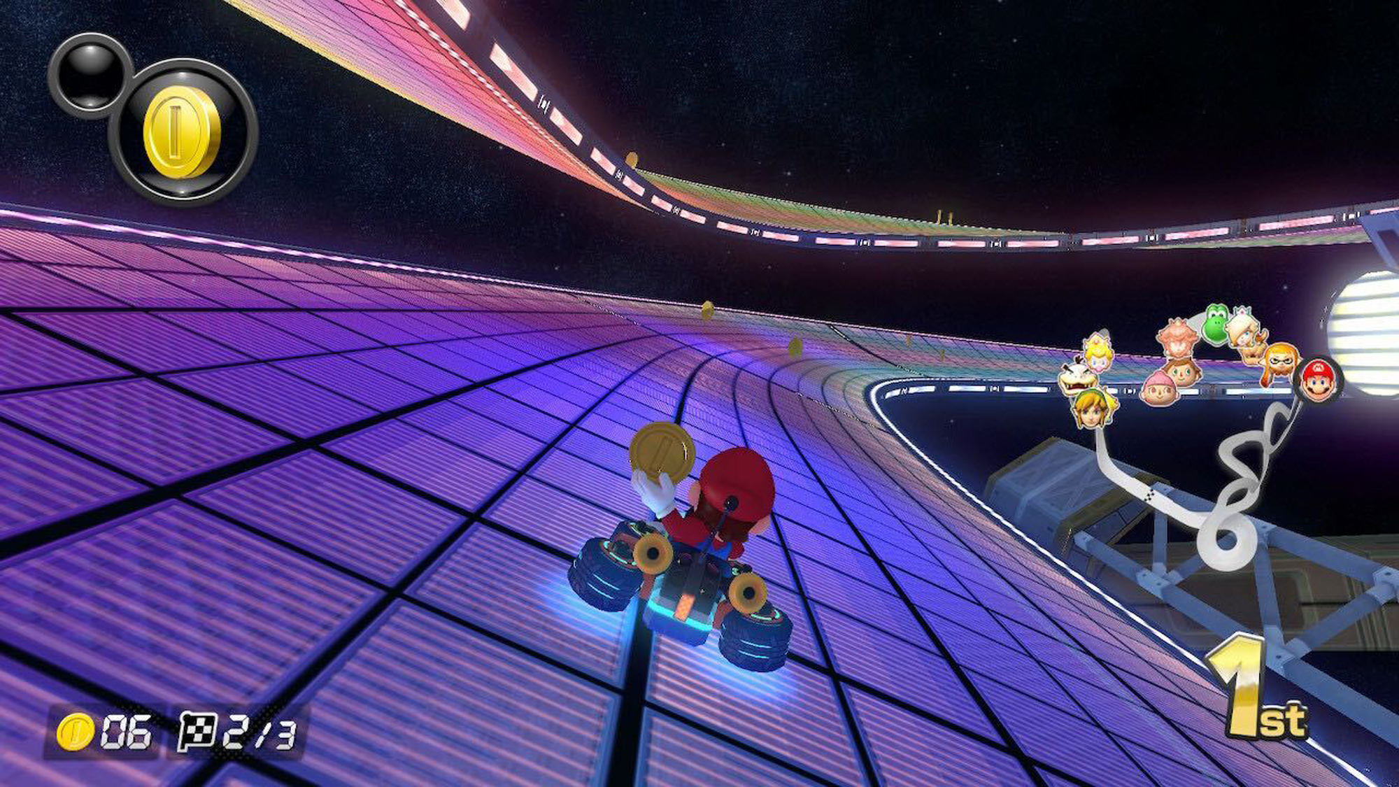 A photo of Mario Kart. Mario is visible in his kart holding a coin on the Rainbow Road level.