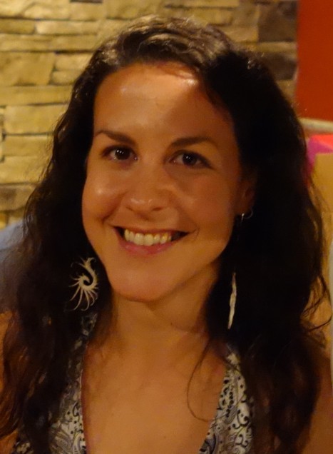 Headshot of Joelle Renstrom, a College of General Studies senior lecturer in rhetoric. He has brown wavy hair and wears dangly earrings.