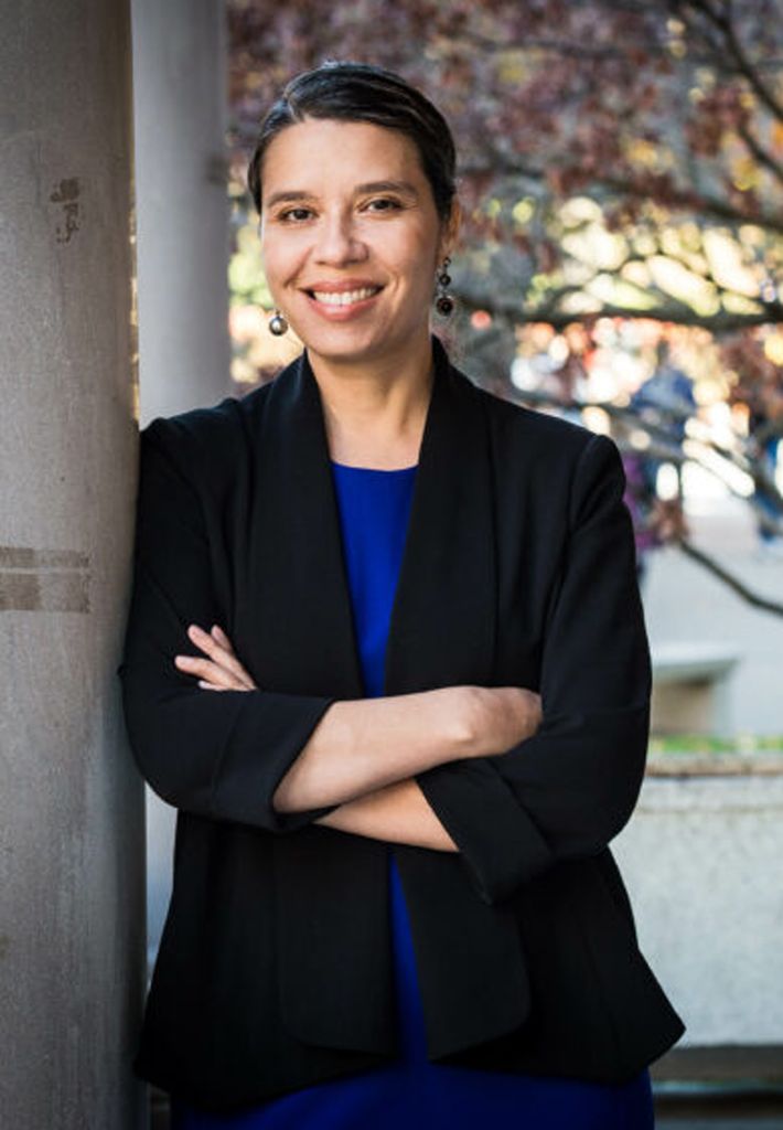 A photo of JASMINE GONZALES ROSE standing with her arms crossed