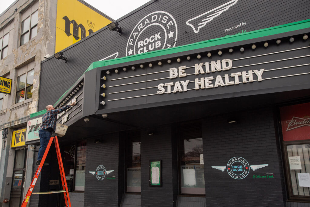An employee at the Paradise Rock Club on Commonwealth Ave. changes the letters on the club's marquee to read "Thanks for the memories, Tom GOAT" and "Be Kind, Stay Healthy"